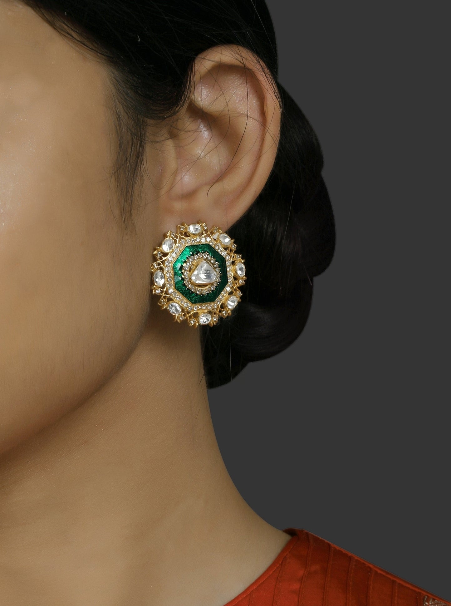 Featuring a pair of 18kt Gold plated studs with uncut polki and green enamel border with diamonds set in 92.5 Silver.