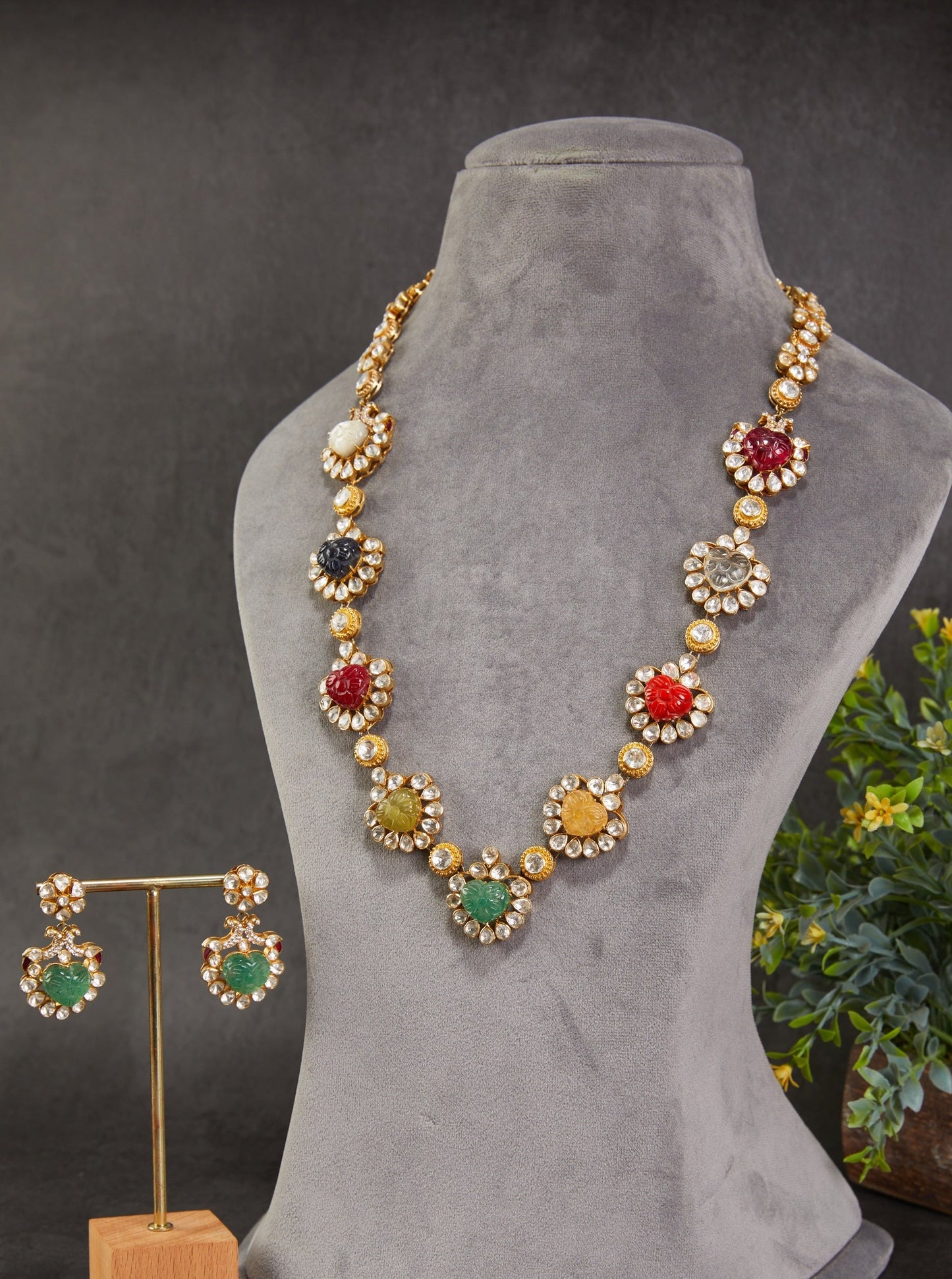 Featuring an 18kt gold plated silver polki necklace set with multicolor carved ston