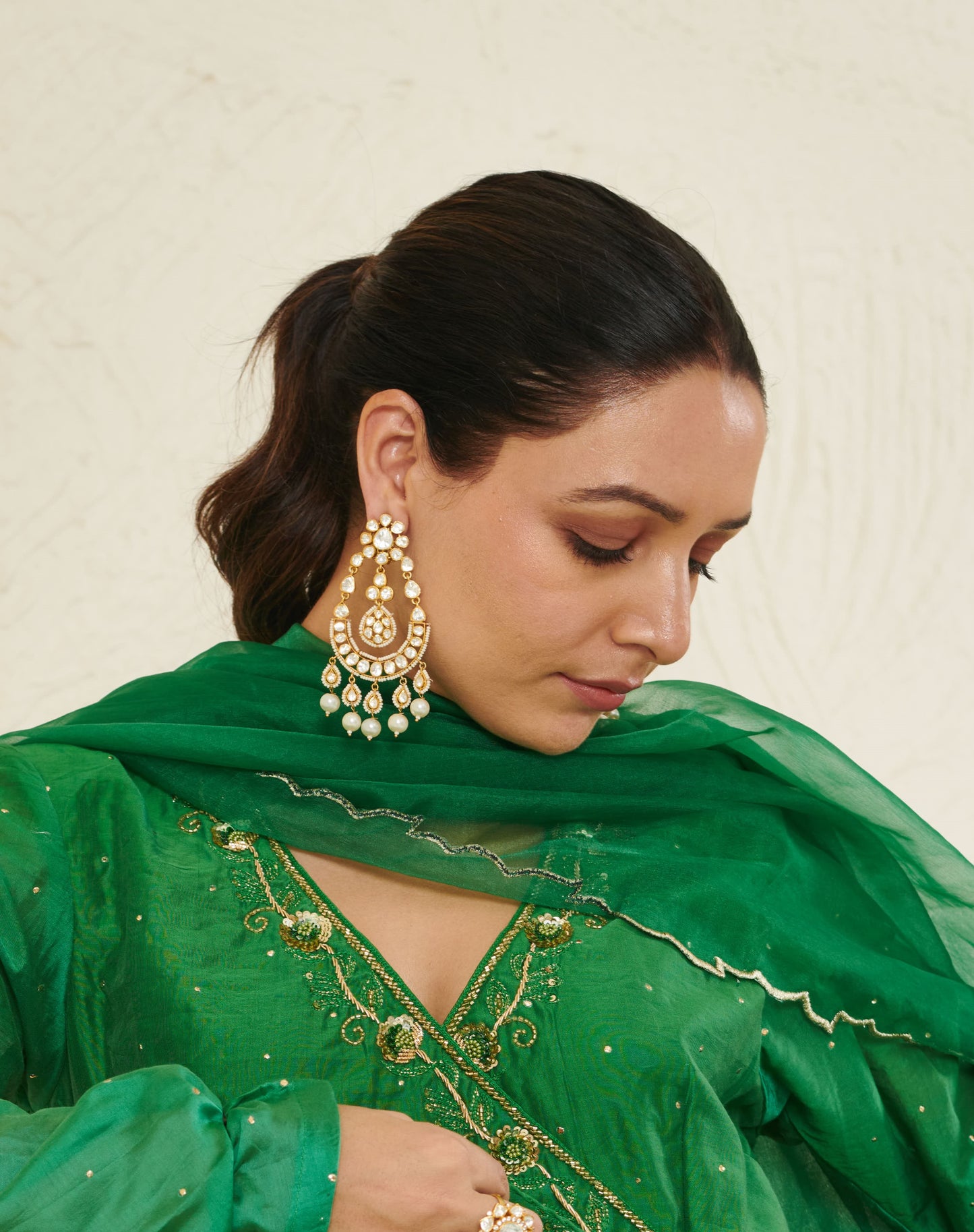 Featuring an 18kt gold plated 92.5 silver Vellore Polki long Chaandbali earring with fresh water pearls drops.