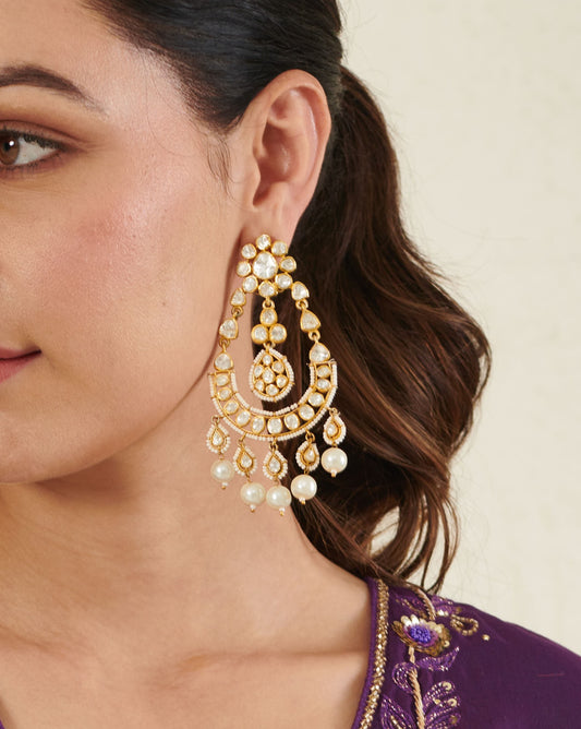 Featuring an 18kt gold plated 92.5 silver Vellore Polki long Chaandbali earring with fresh water pearls drops.