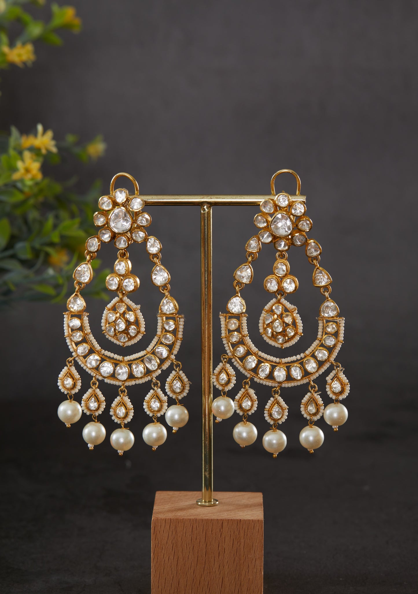 Featuring an 18kt gold plated 92.5 silver Vellore Polki long Chaandbali earring with fresh water pearls drops.