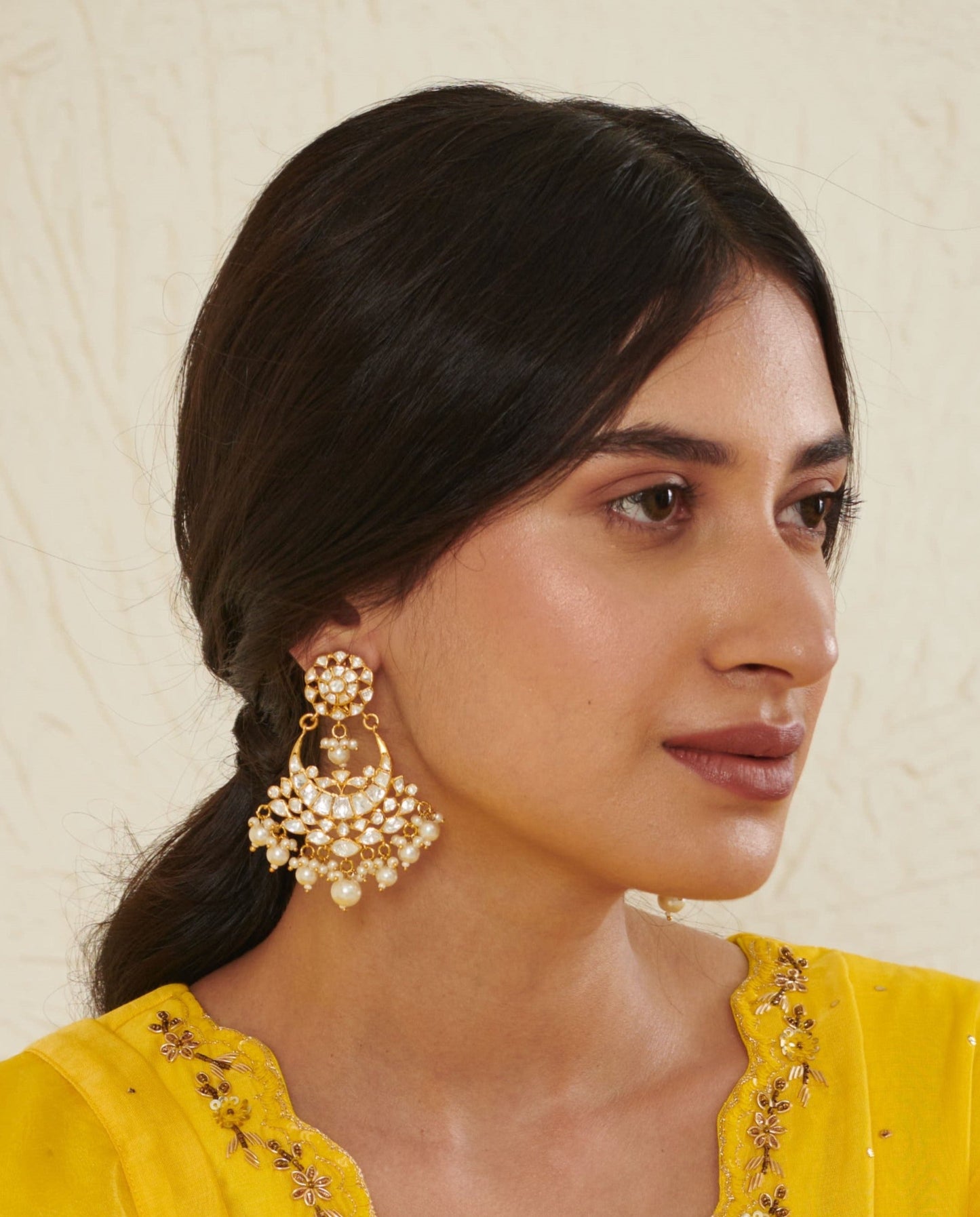 Featuring an 18kt gold plated 92.5 silver Vellore polki moon motif Chaandbali earring with fresh water pearls drops.