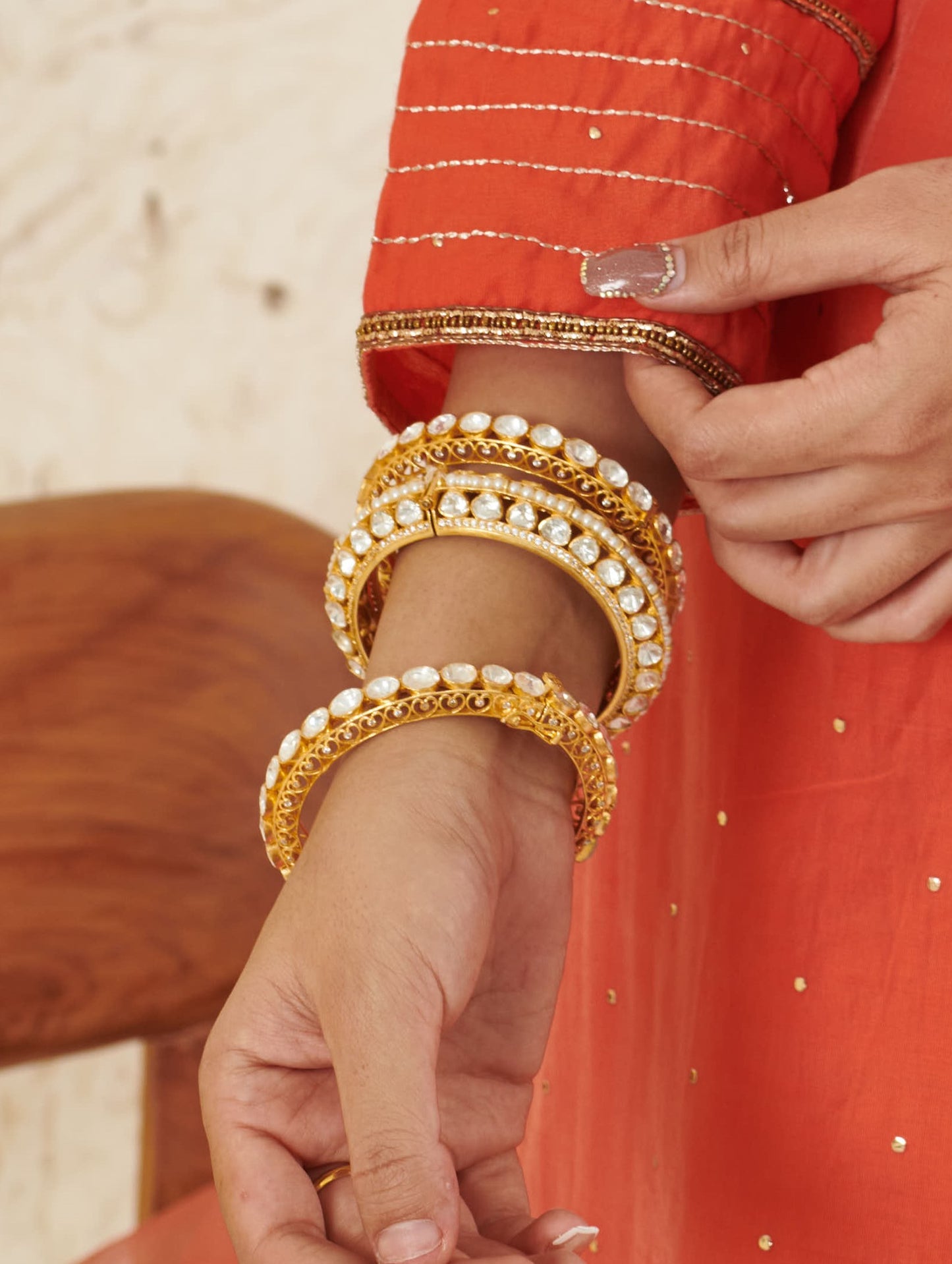 Featuring an 18kt Gold Plated 92.5 silver moissanite 2 sided polki studded kada with pearl line in center.