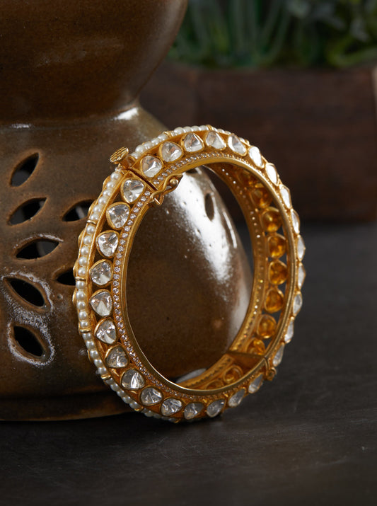 Featuring an 18kt Gold Plated 92.5 silver moissanite 2 sided polki studded kada with pearl line in center.