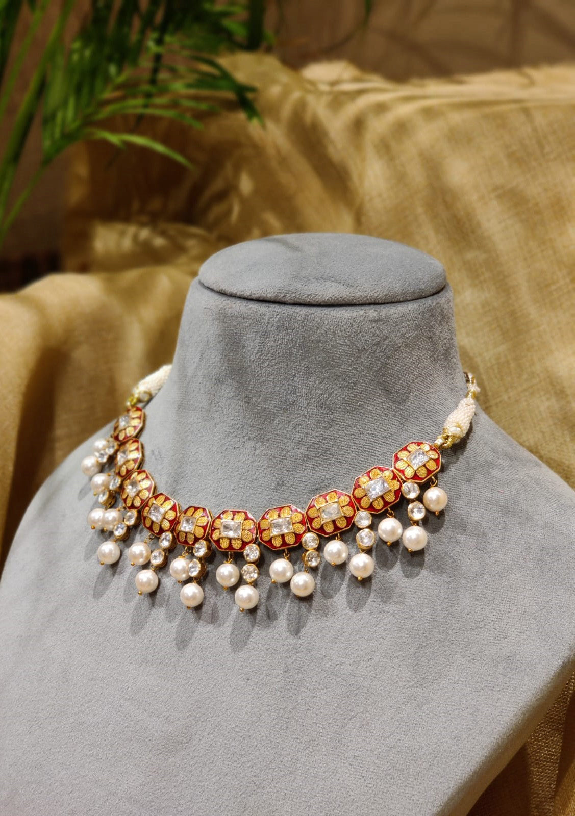 Featuring an 18kt Gold plated silver red enamel & polki floral texture necklace set in 92.5 Silver.