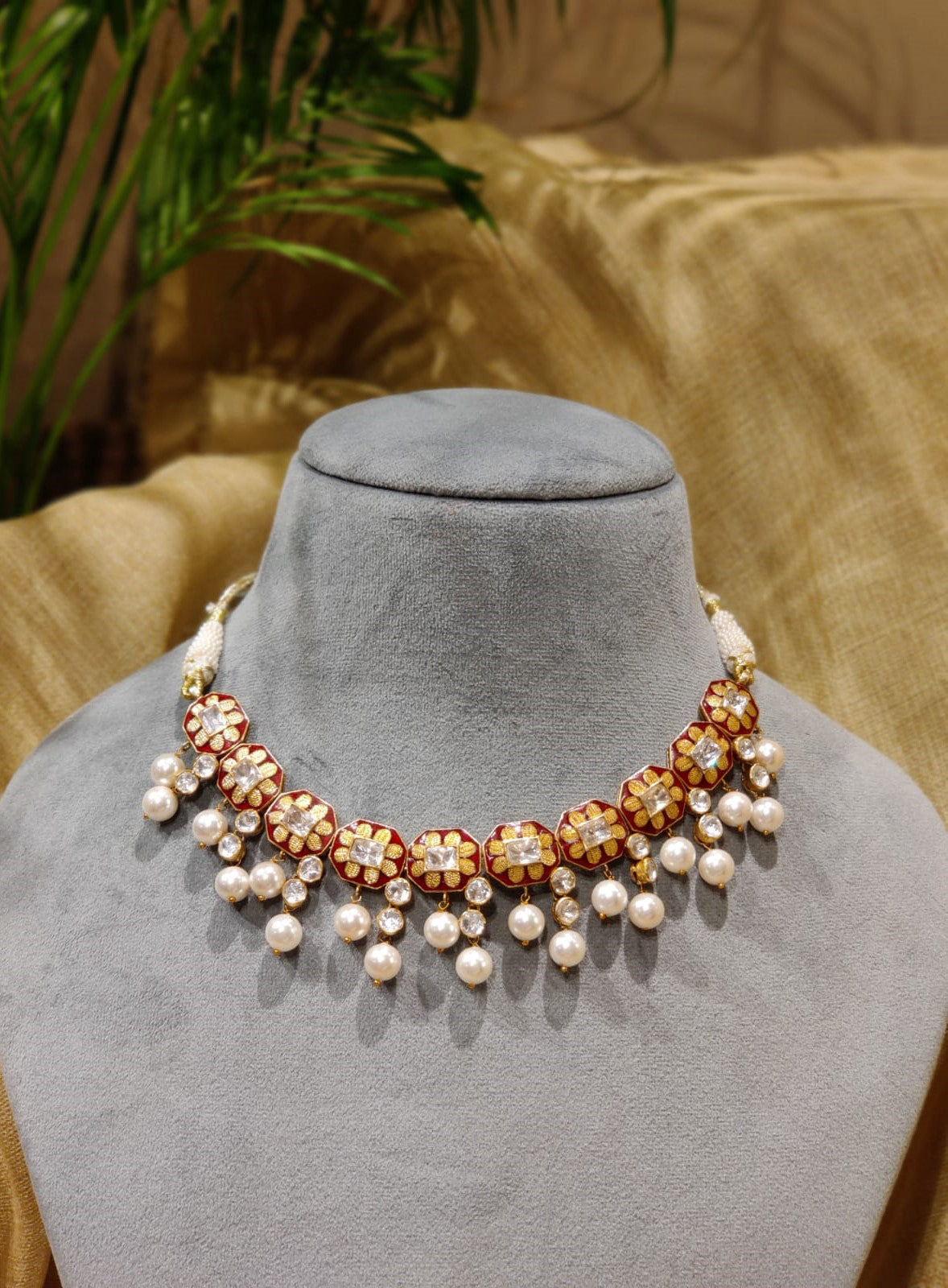 Featuring an 18kt Gold plated silver red enamel & polki floral texture necklace set in 92.5 Silver.