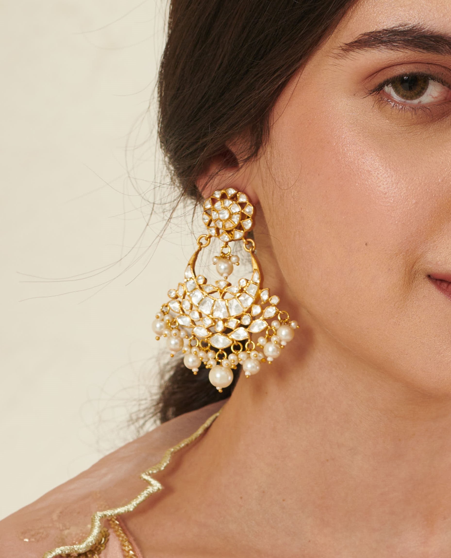 Featuring an 18kt gold plated 92.5 silver Vellore polki moon motif Chaandbali earring with fresh water pearls drops.