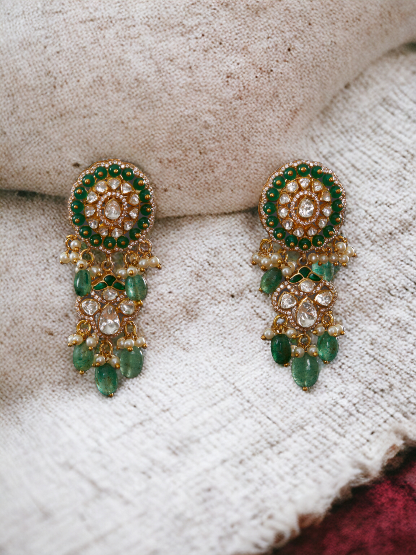 Vellore polki oval motif dangler earrings with green beads and drops.