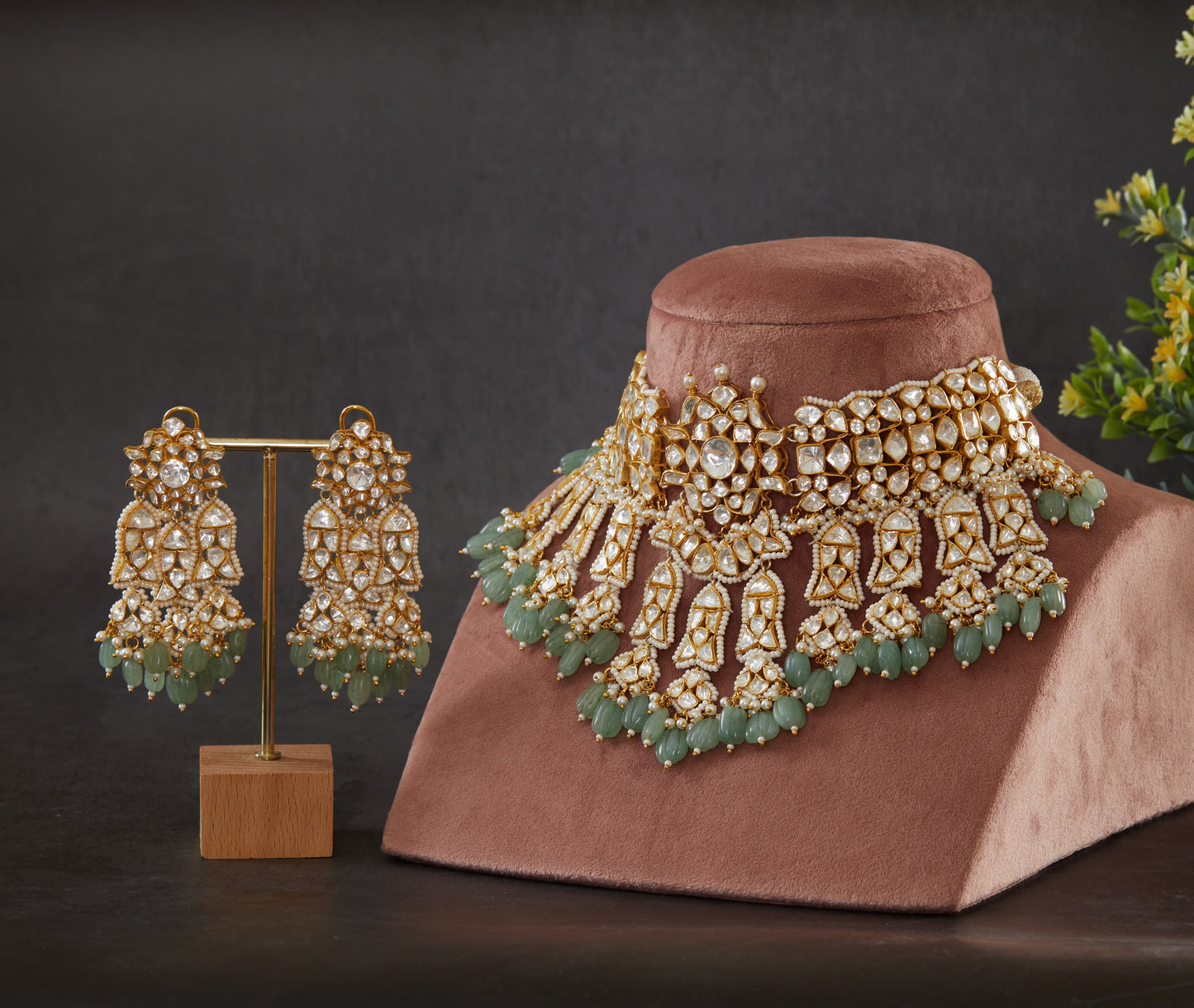 Featuring an 18kt gold plated 92.5 silver Vellore polki heavy choker set with green carved drops & fresh water pearls.