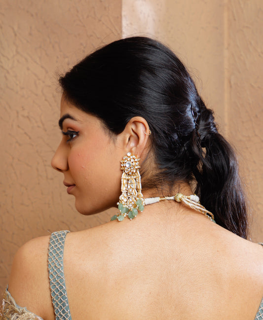 Featuring an 18kt gold plated 92.5 silver Vellore polki heavy earring with green carved drops & fresh water pearls.