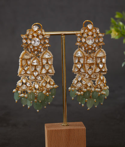 Featuring an 18kt gold plated 92.5 silver Vellore polki heavy earring with green carved drops & fresh water pearls.